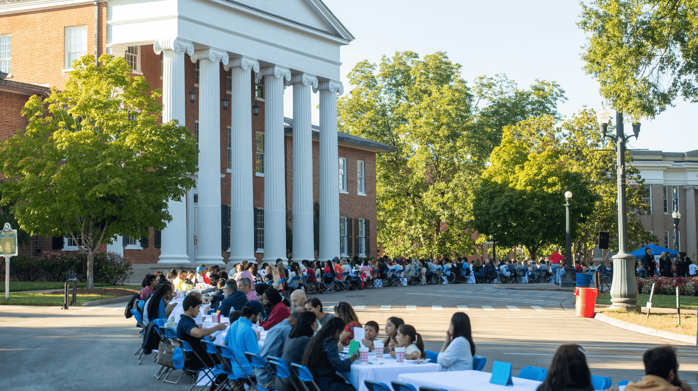 Community gathers around long table event