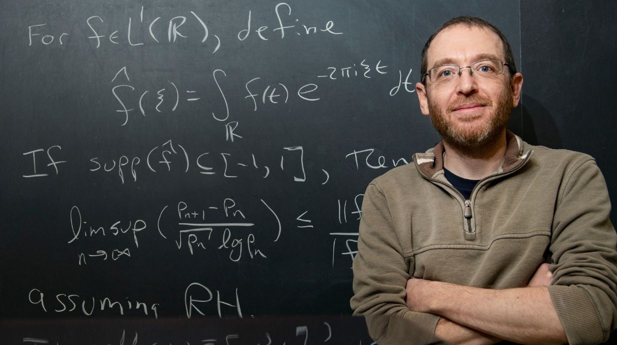 Researcher in front of board