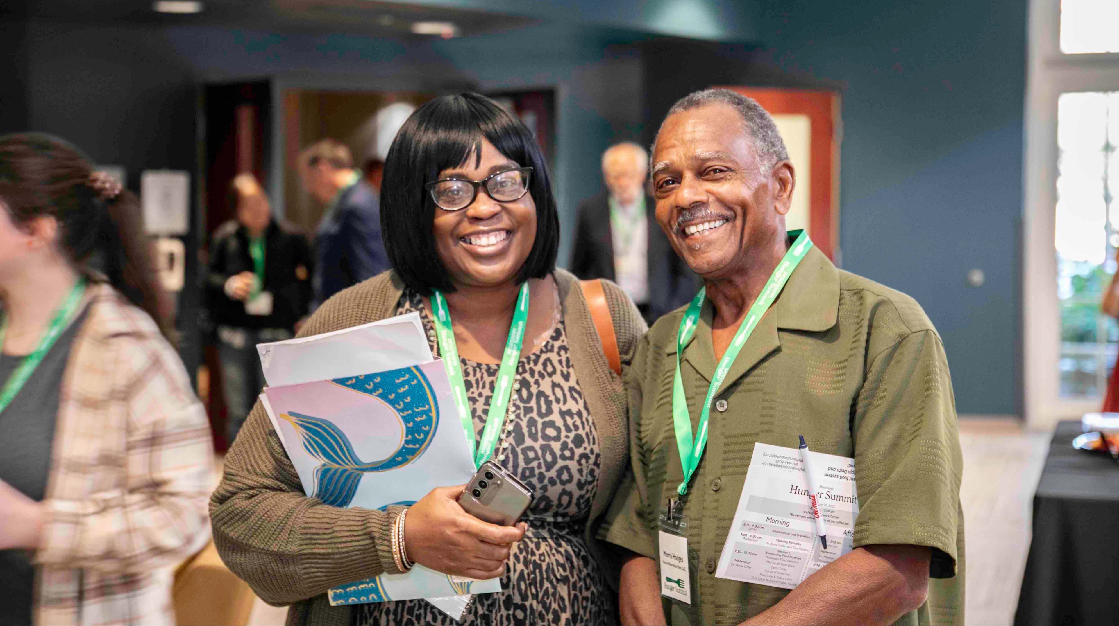 Two conference participants smile.