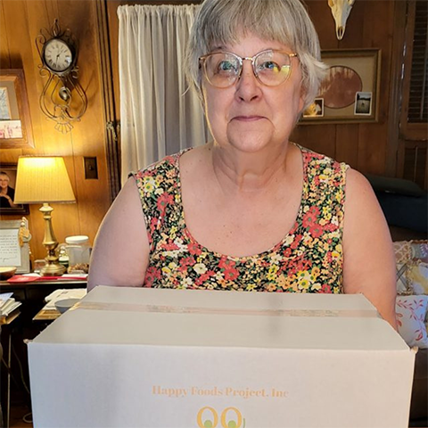 Woman receives a food prescription box