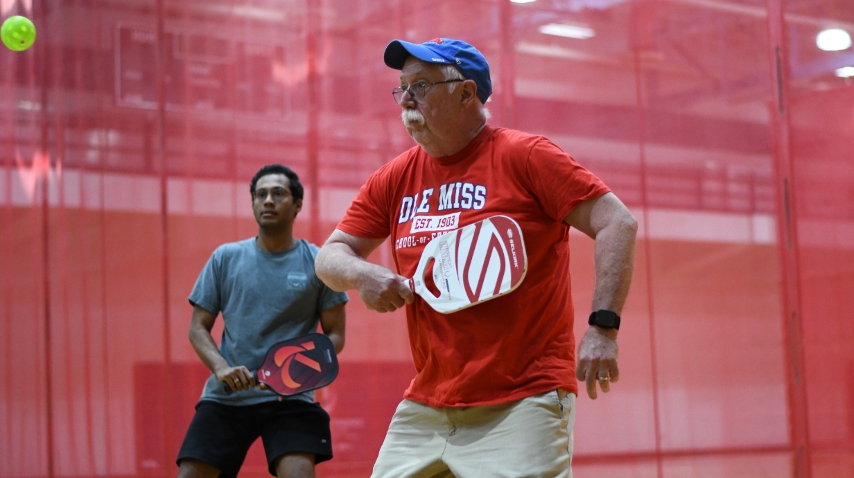 Two employees playing pickleball