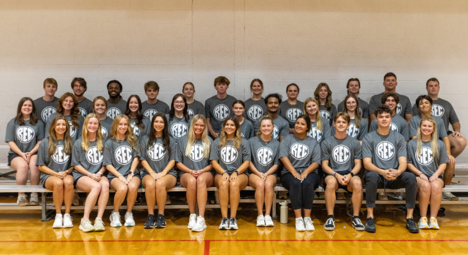 Aquatics student employees sitting on bleachers.