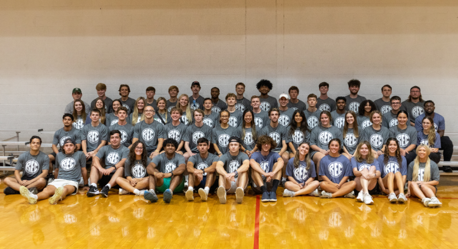 Intramural Sports & Sport Clubs student employees sitting on bleachers.