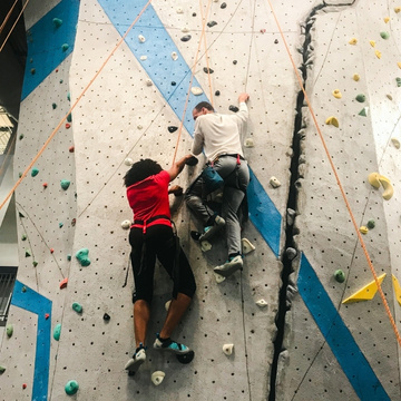 Two people climbing in the South Campus Recreation Center