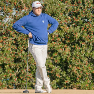 Golfer leaning on golf club