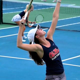 A tennis player about to serve.