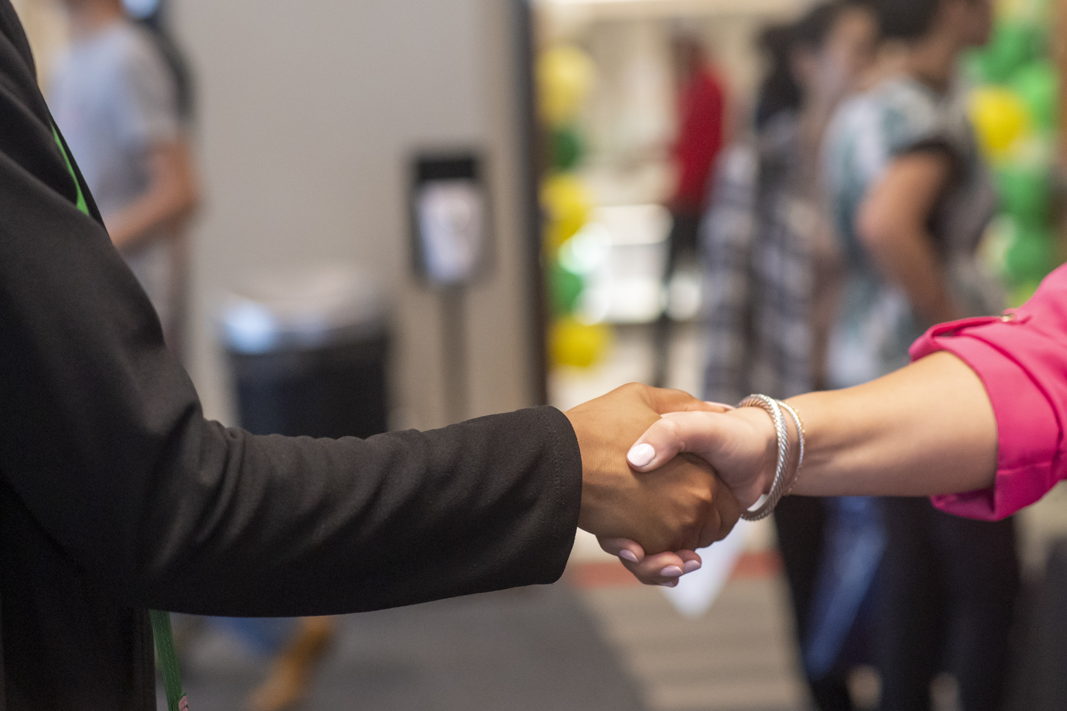 Image of two people shaking hands.