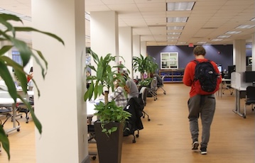 student walks through library