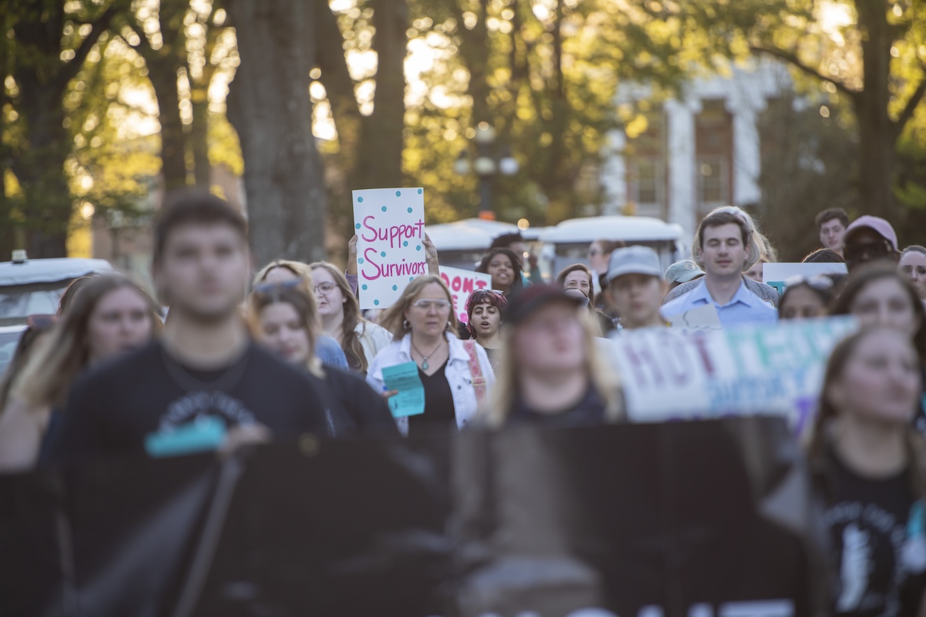 A participant in Take Back the Night holds a sign.