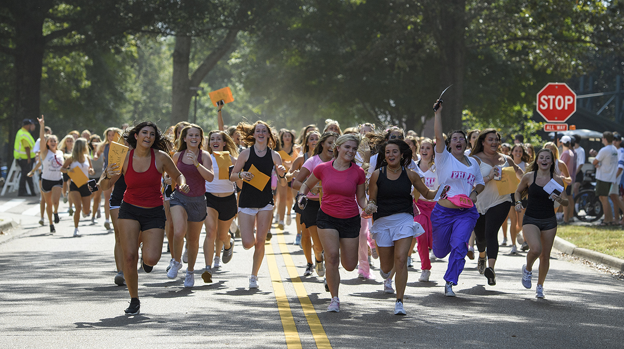 New sorority members run to their houses on Bid Day after receiving bids