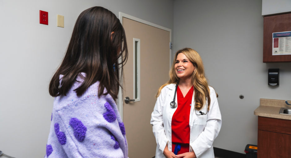 Provider smiles talking with patient.