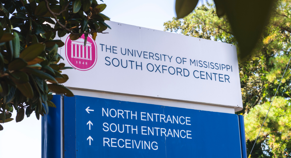 Sign showing direction to enter the Student Health clinic.