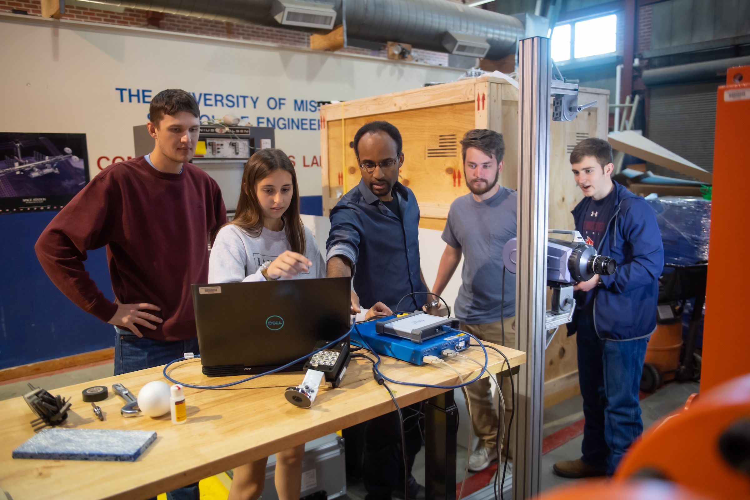 Students and faculty work on a research project, illustrating the academic and career opportunities available at Ole Miss. 