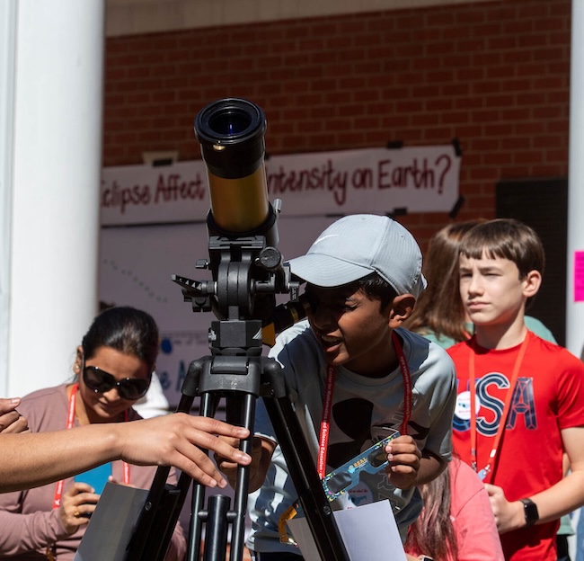 Students attend a demonstration on the solar eclipse.