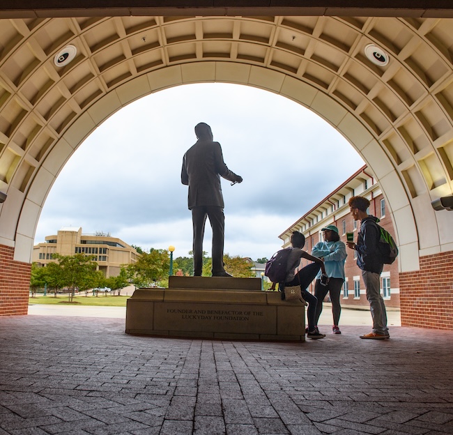 Students mingle outside Luckyday Hall. 