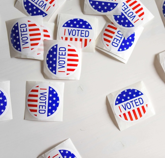 "I Voted" stickers sit on a table. 