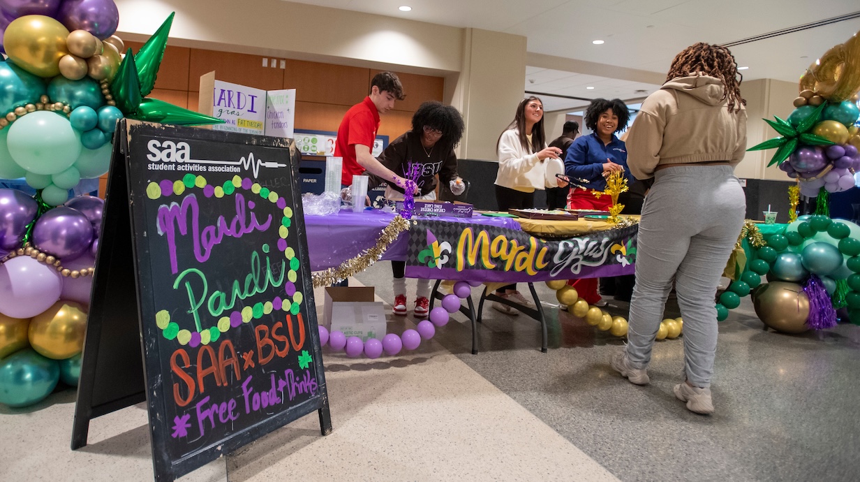 The Student Activities Association and Black Student Union welcome guests to a joint Mardi Gras celebration. 