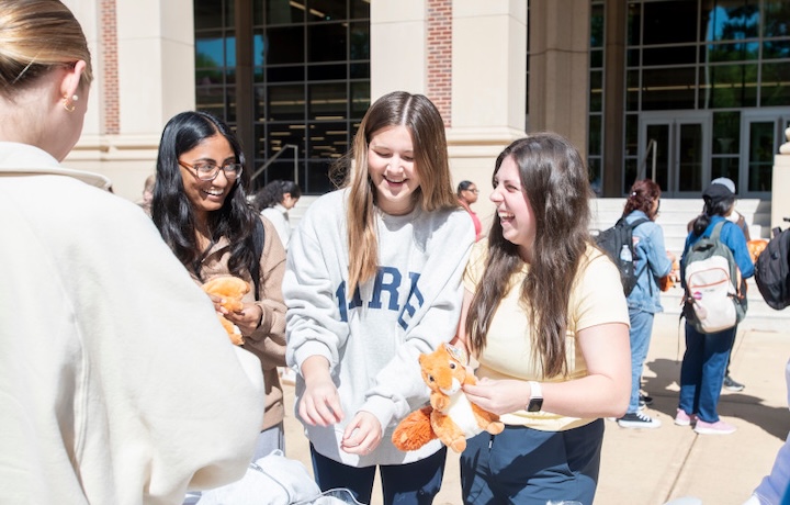 Students pose with stuffed Grove squirrels as part of Landshark Week.