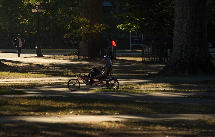 An individual rides a therapy bike across 