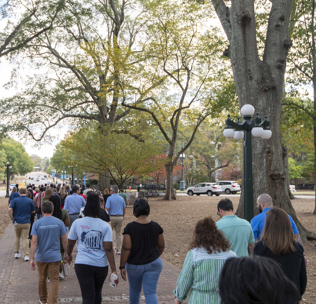 Employees walk across campus.