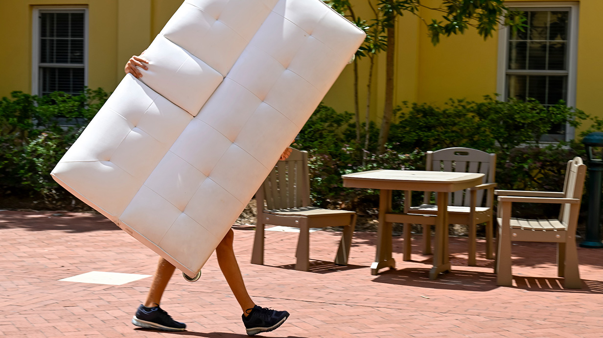 person moving a couch