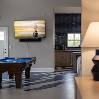 Photo of a lamp with a pool table in the background