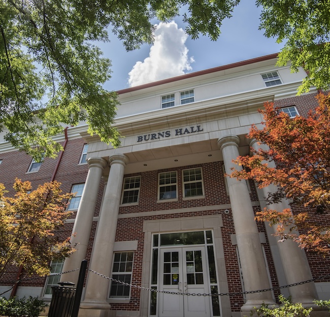 Photo of the outside of Burns Hall fall colored leaves