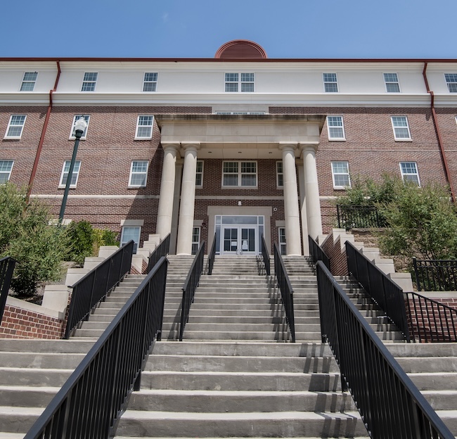 Photo of the outside of Residence Hall 1 and outdoor staircase