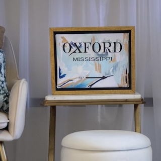 Sign on table next to chair stating "Oxford, Mississippi"