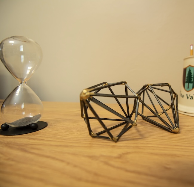 Hourglass and items on desk 