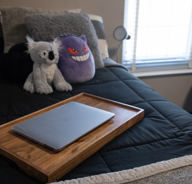 Laptop on lap desk sitting on bed 
