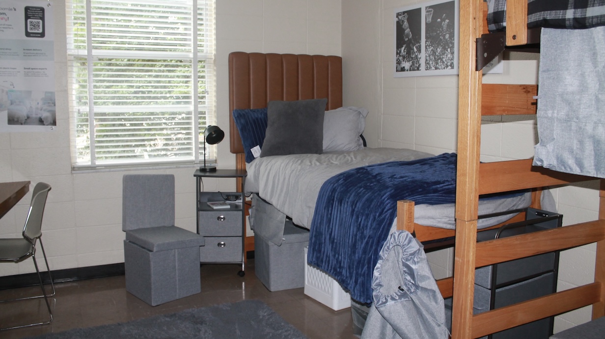 Bed and chair sitting in front of window