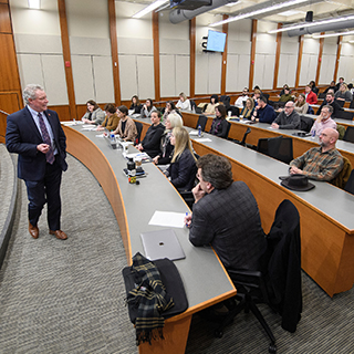 Chancellor speaking to a group of people 