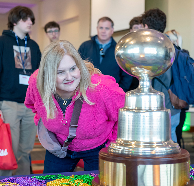 Woman looking at the egg bowl trophy