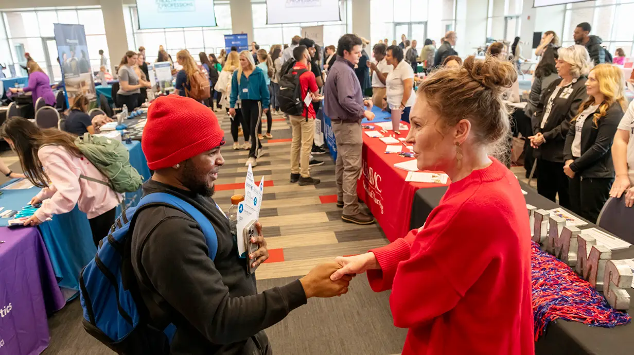 Students meet with company representatives at the Health Professions Fair in the Student Union Ballroom.