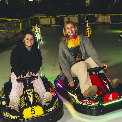 Students ride go-karts.