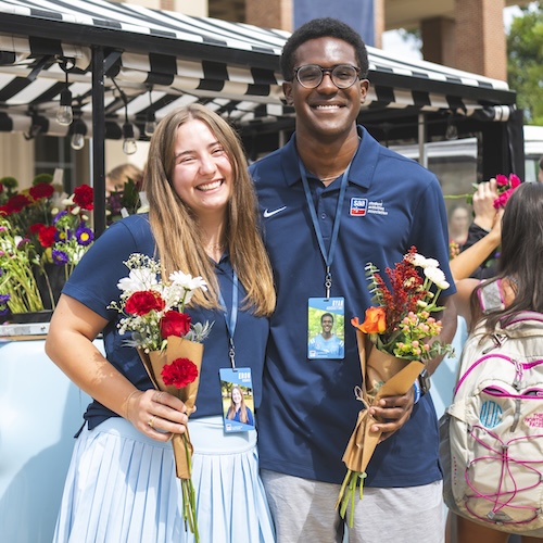 Students purchase flowers from a vendor on the Union Plaza.
