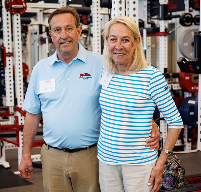 couple posing in ole miss training facility