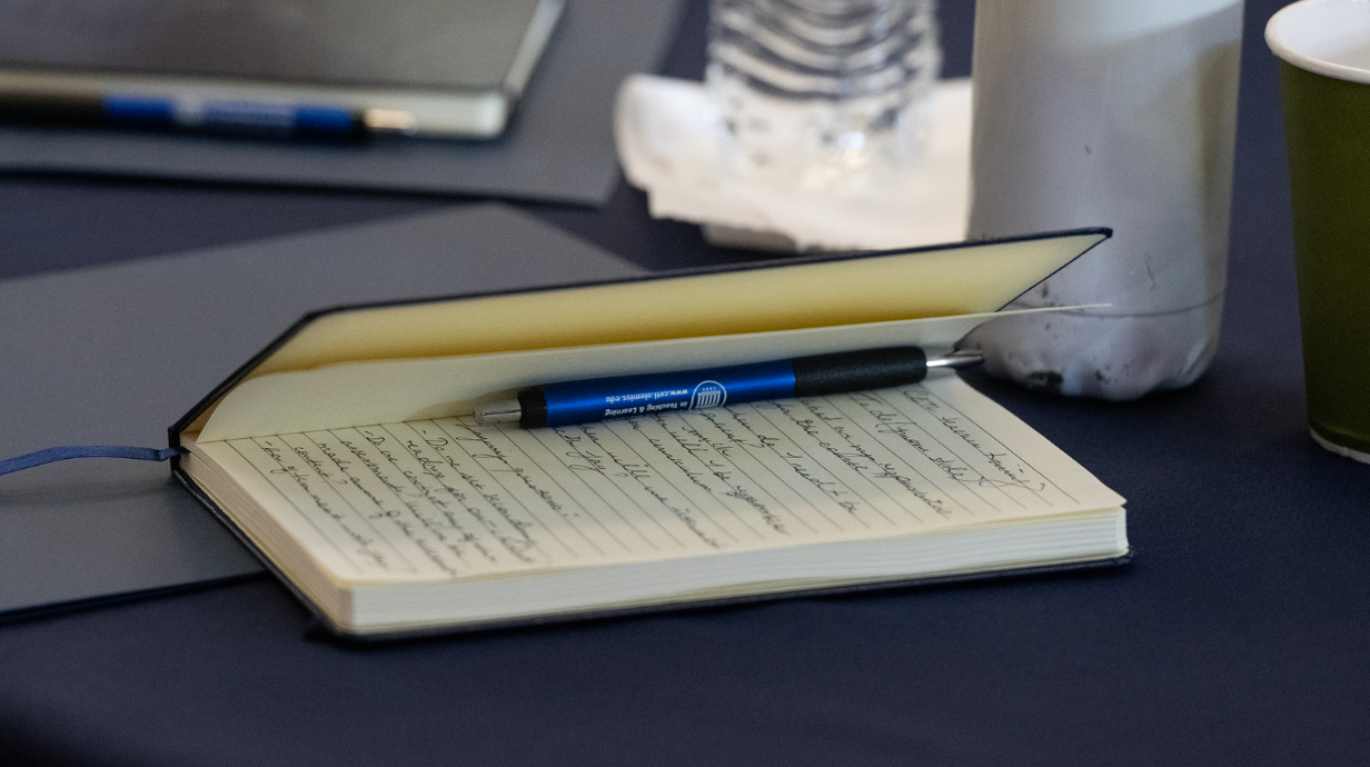 A notebook sits on a table at graduate teaching orientation