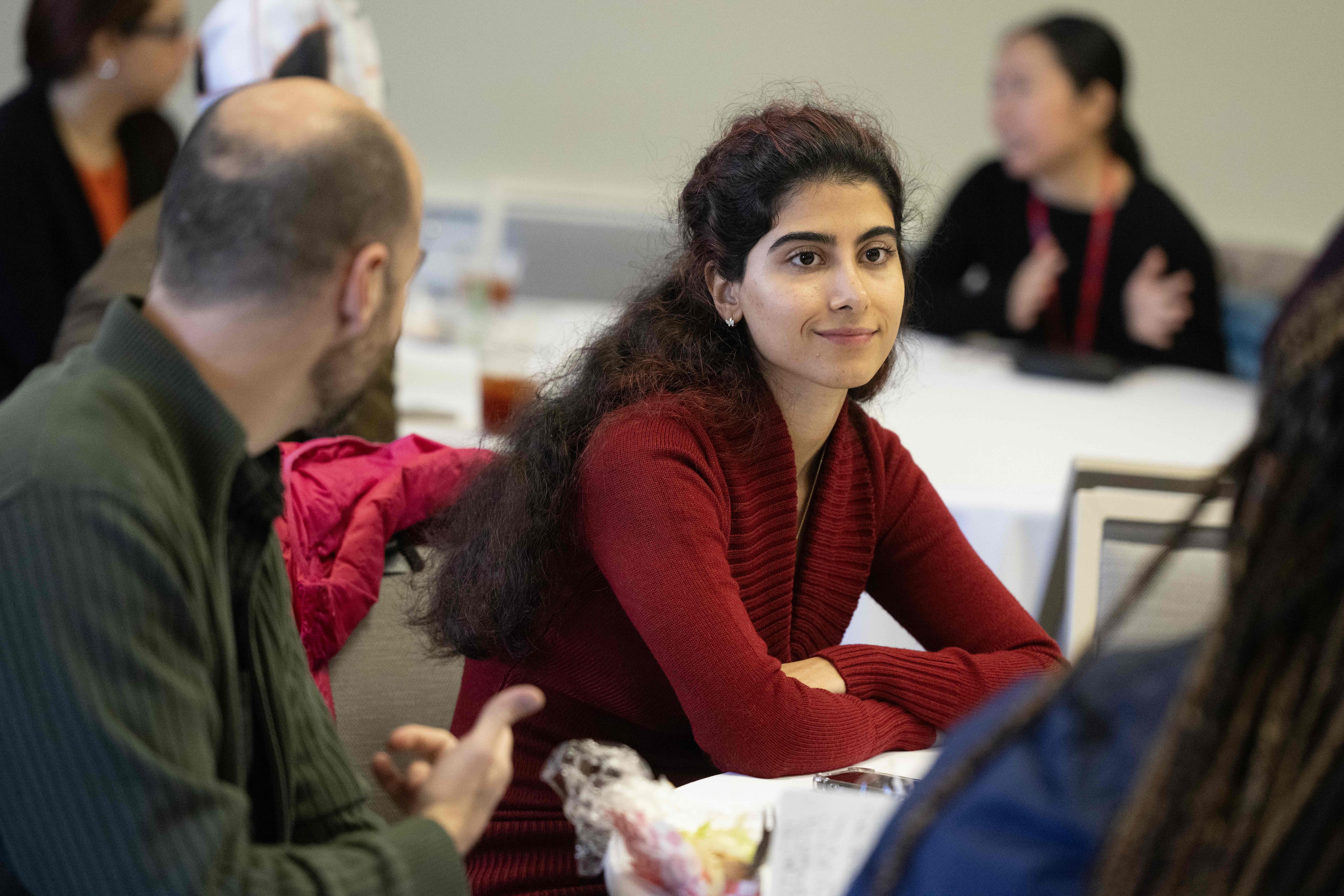 An attendee listens to others talk around a table at a CETL workshop 