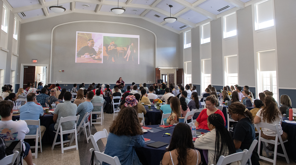 A room full of students sitting at tables at Graduate Teaching Orientation