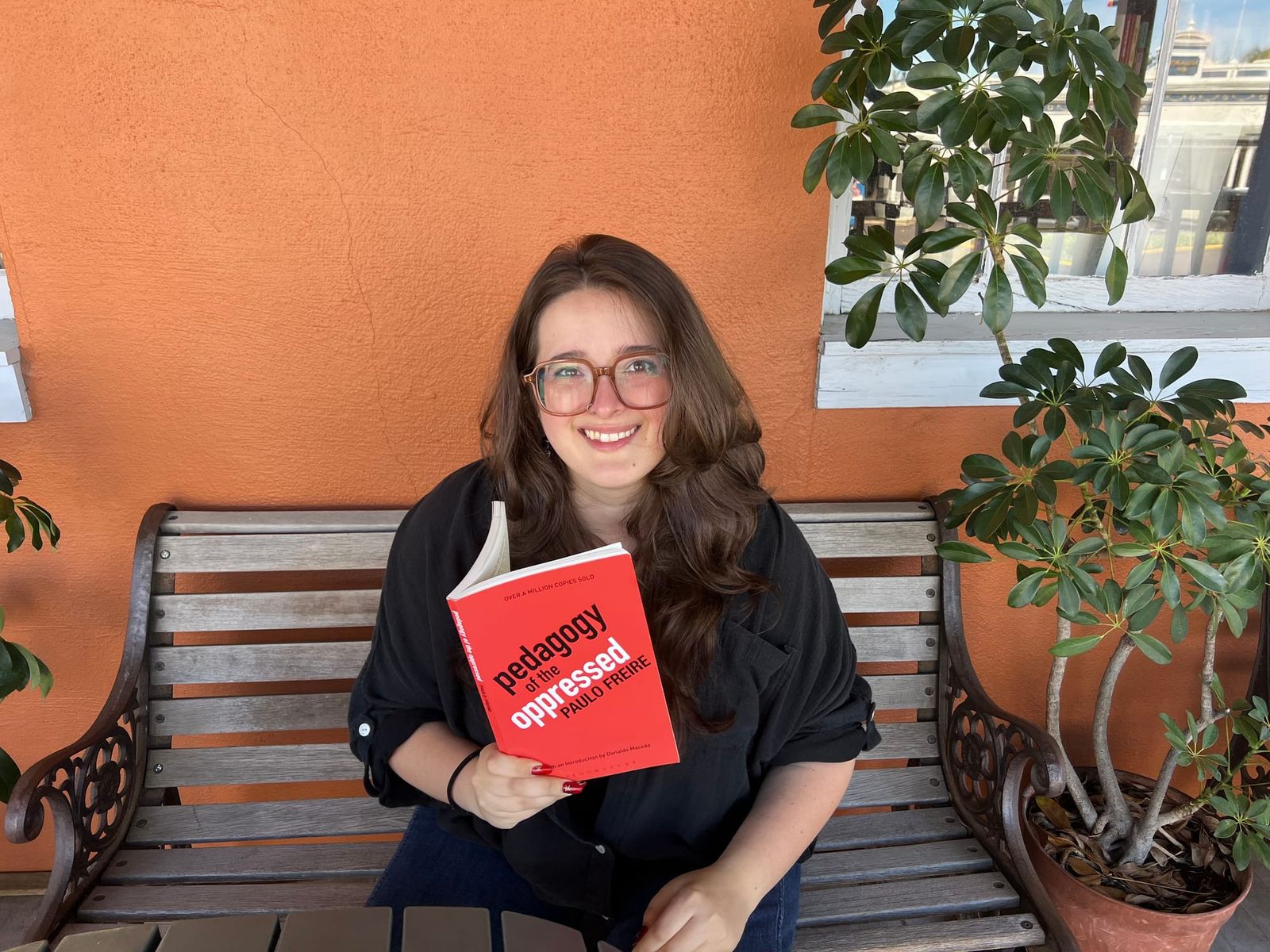 Anna holding a copy of "Pedagogy of the Opressed"