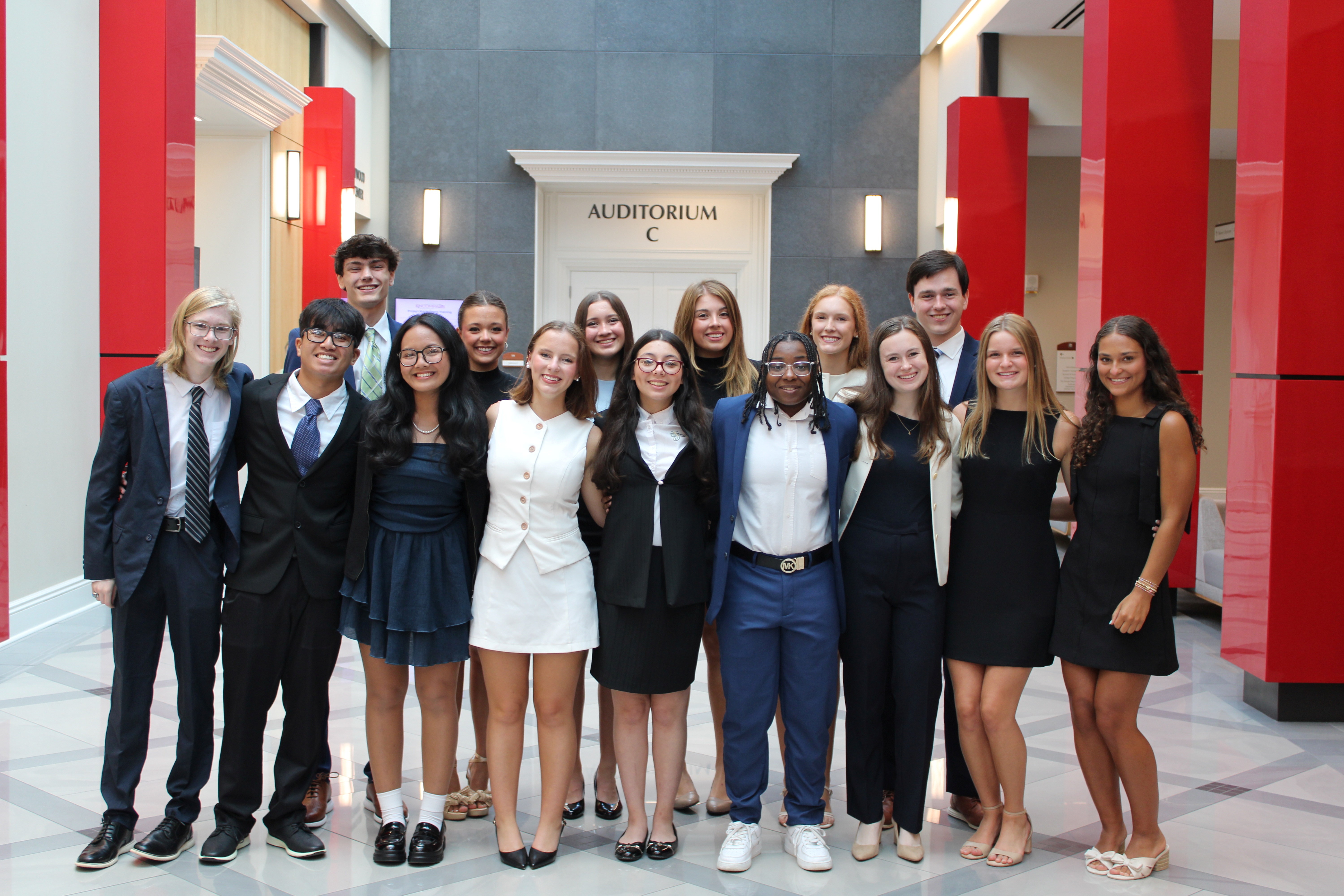Students posing for a group photo in a conference center