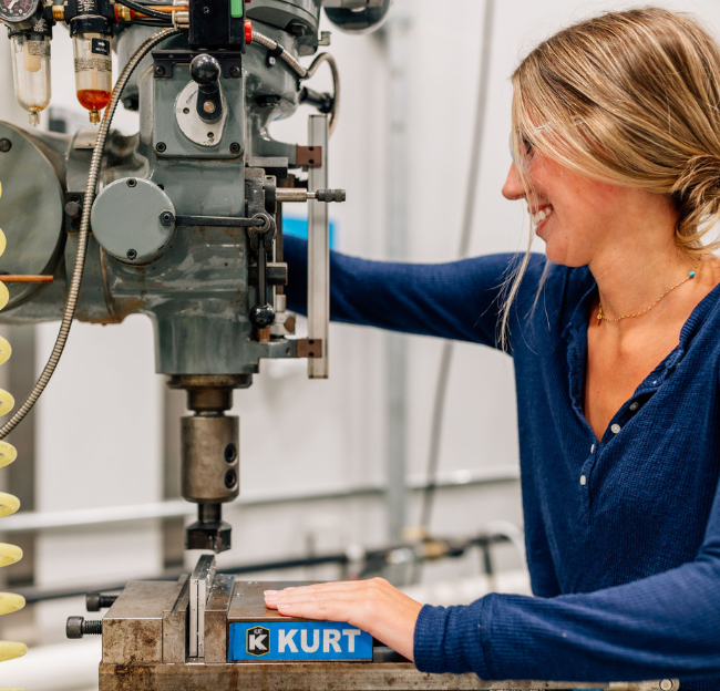 CME students work with an instructor on the manufacturing floor