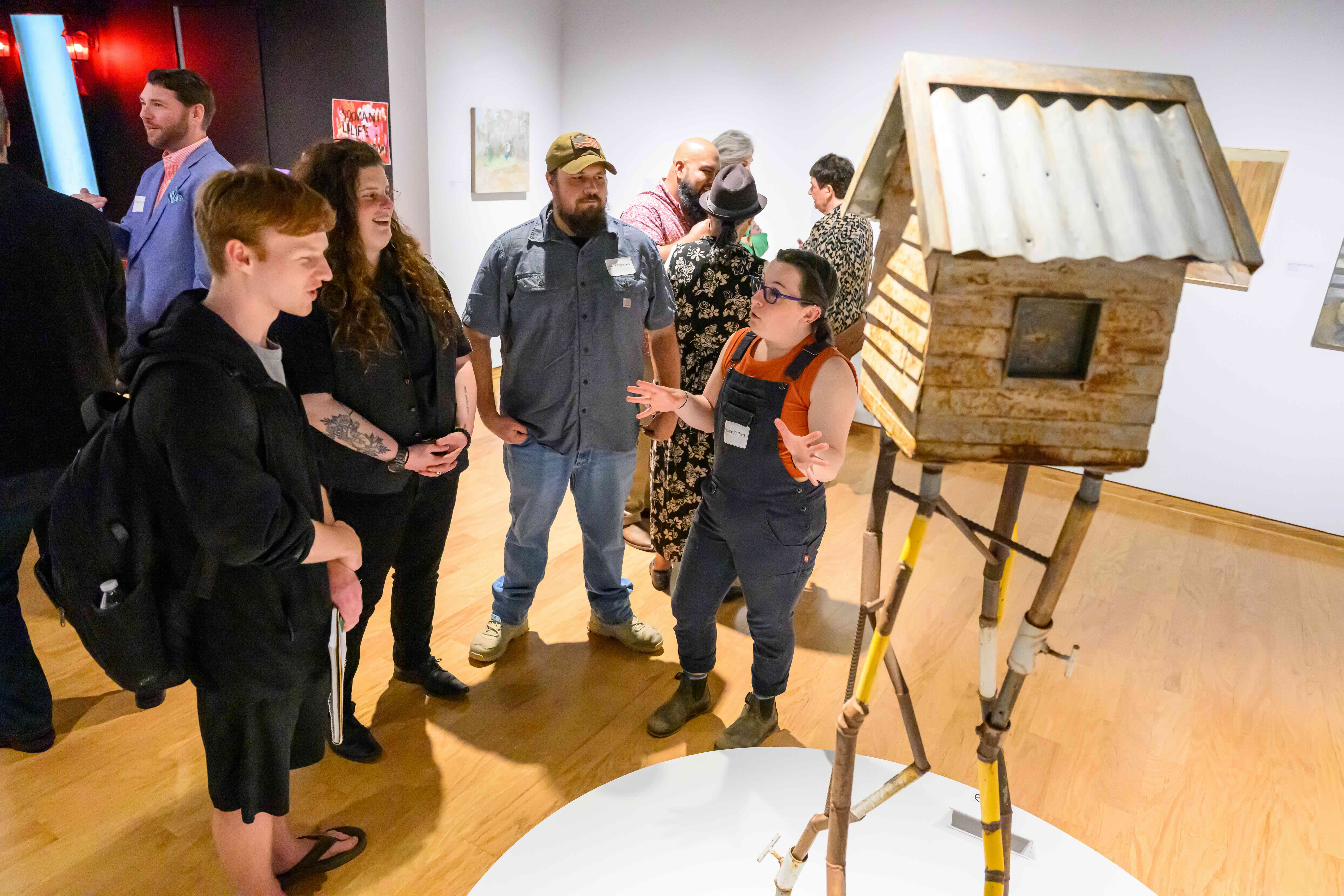 woman explaining sculpture