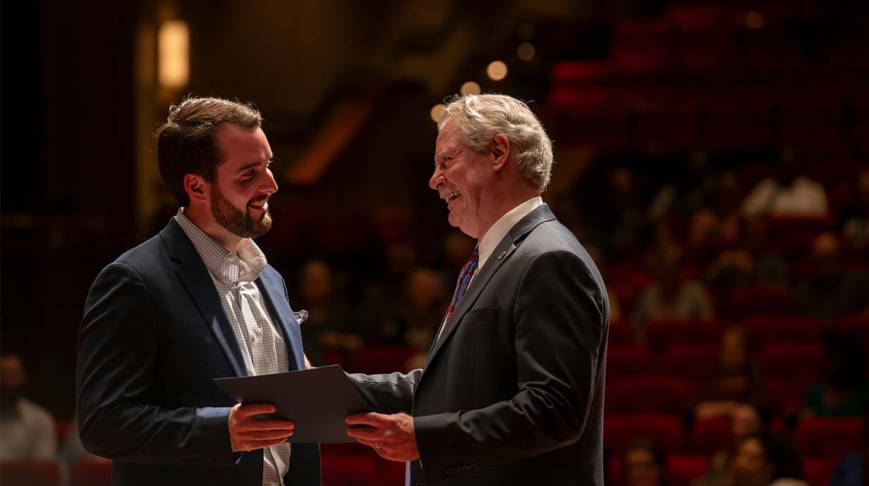 Chancellor Glenn Boyce honors a UM staff member during the Red and Blue Celebration of Staff