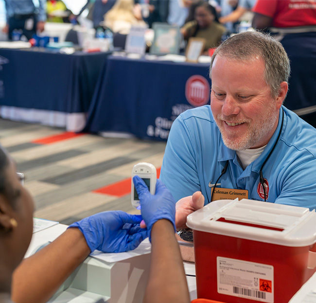 A UM staff member at the Red, Blue, and Well Spring Wellness Expo.