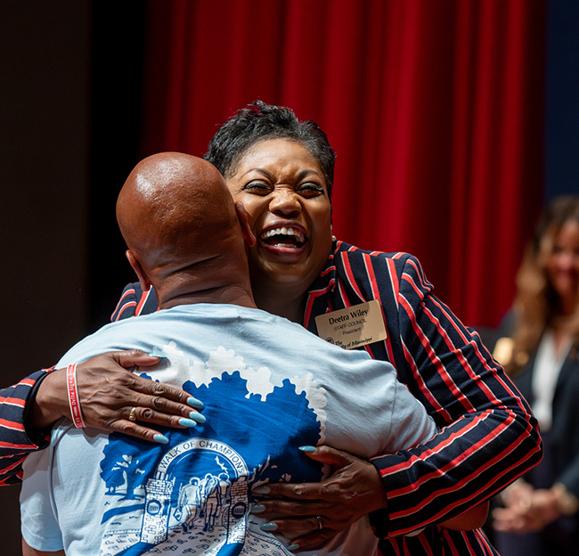 An Ole Miss staff member receives an award.