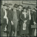 Image of a group of travelers waiting for the train. Howorth Photograph Collection. Circa 1910-1925.