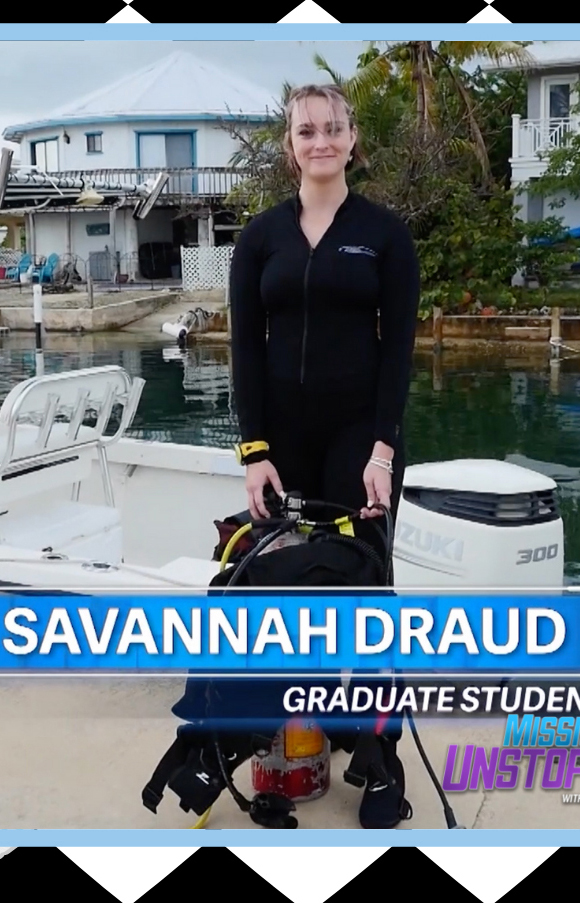A young woman holds diving gear in a screen grab from a television program.